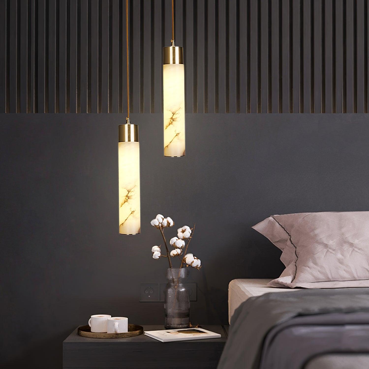 Tala pendants beside a bed and dark wall panelling