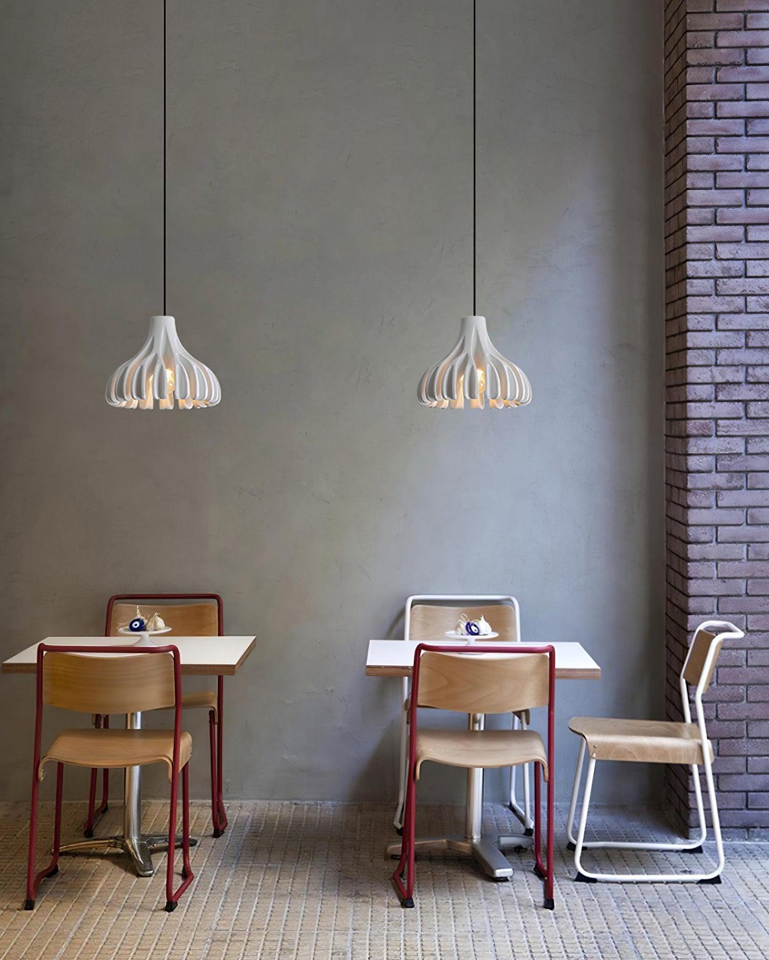Two White resin pendants above small tables