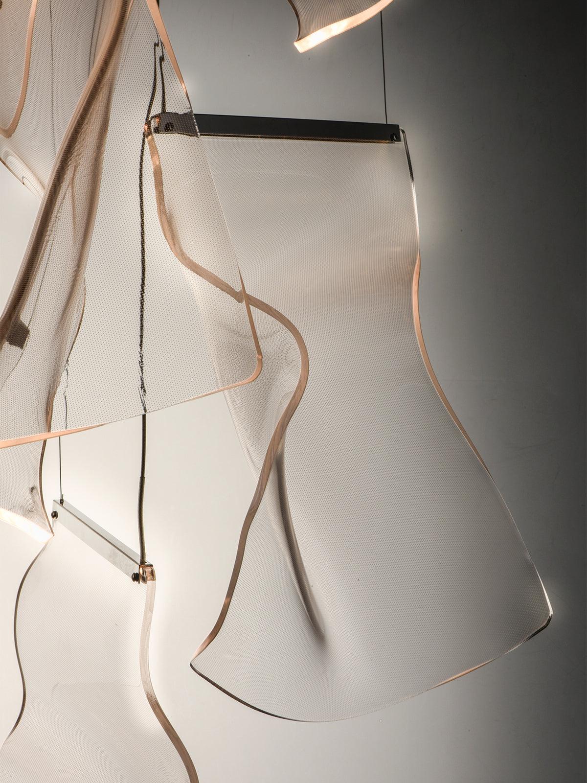 Curved acrylic elements with metal strips along their upper edges
