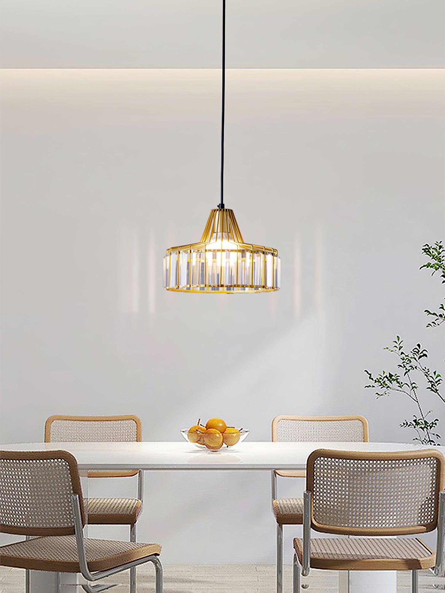 Gold-coloured crystal-glass pendant above a dining table