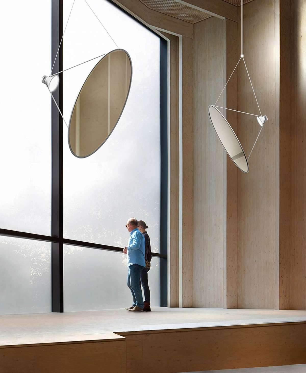 Large disc pendants beside floor-to-ceiling windows