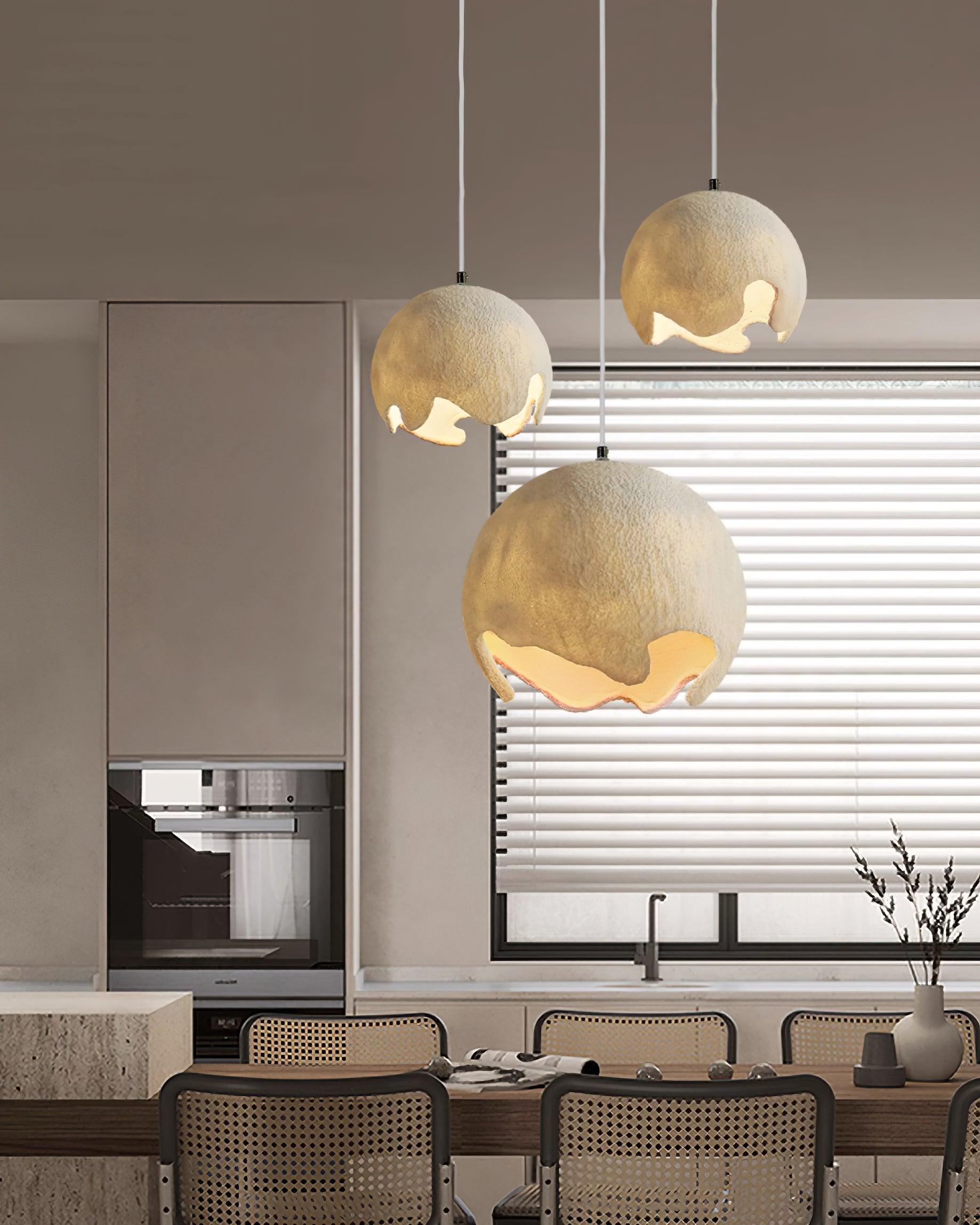 Three beige textured pendants above a kitchen island