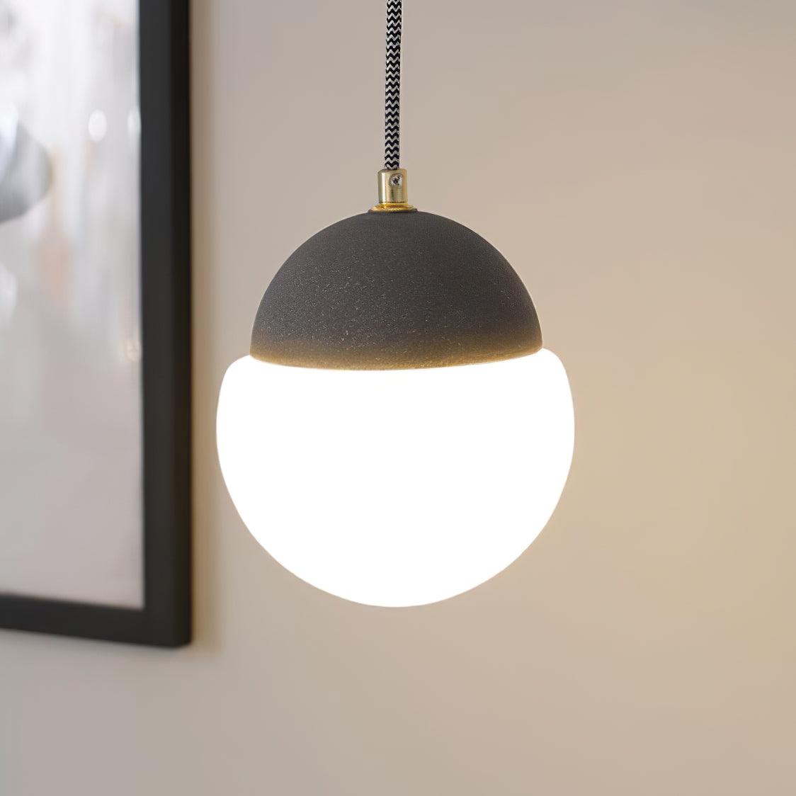Dark granular cap over an illuminated White globe