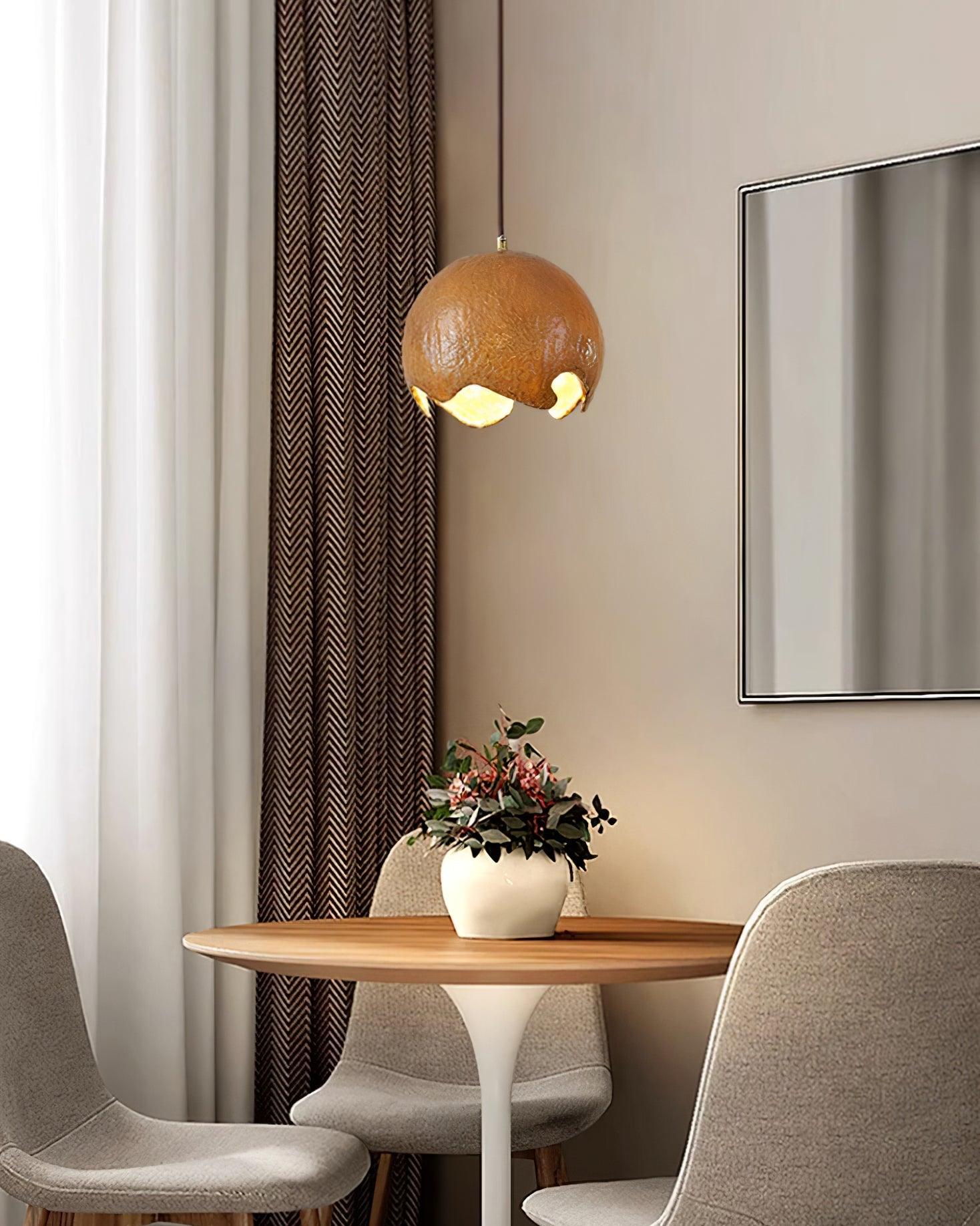 Brown textured pendant above a round dining table