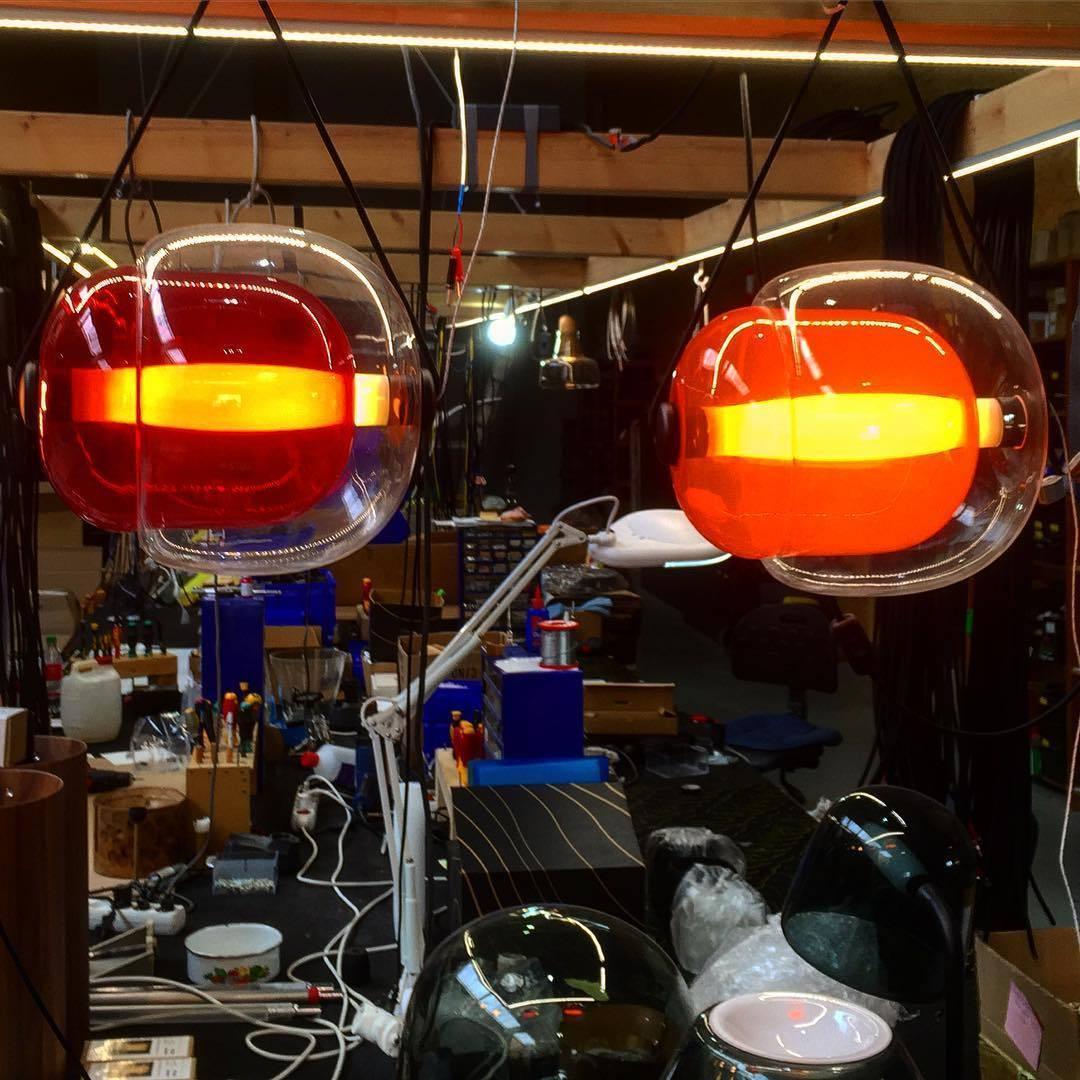 Two glowing red-orange glass pendants