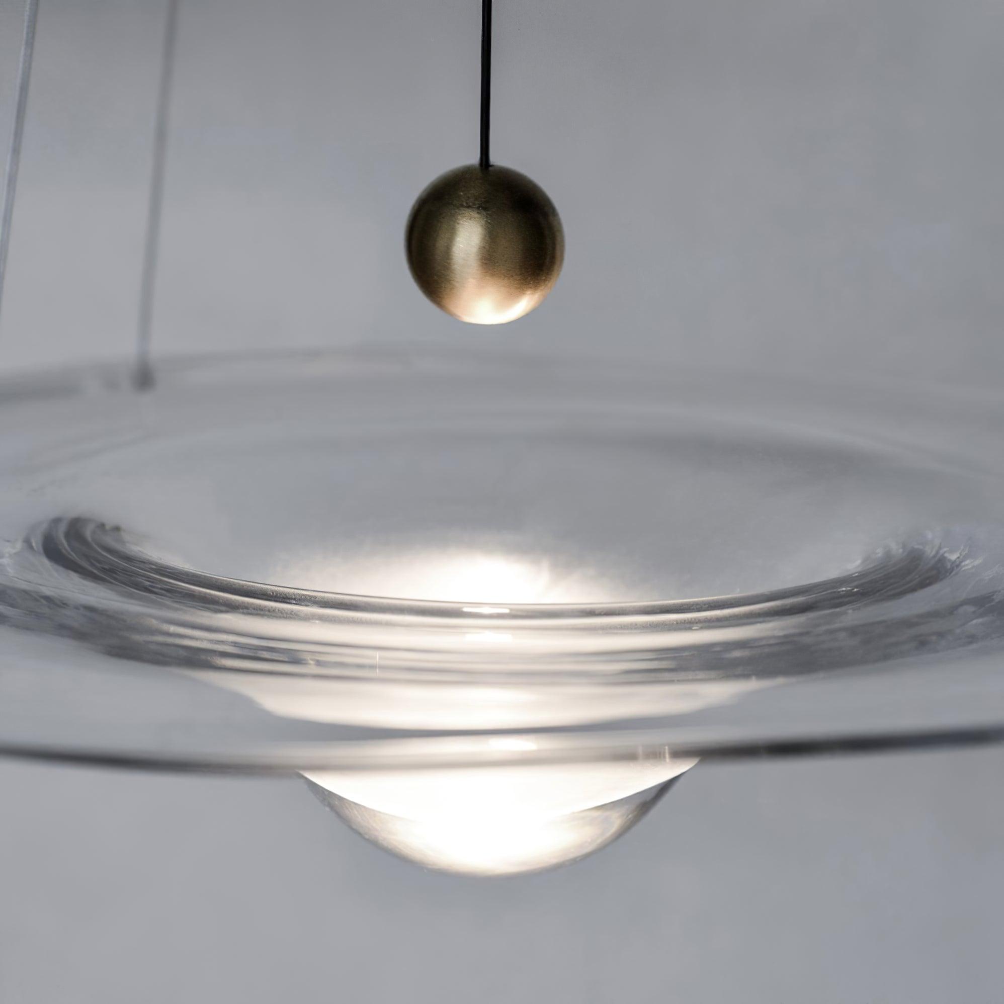 Brass-coloured bead above the clear glass centre