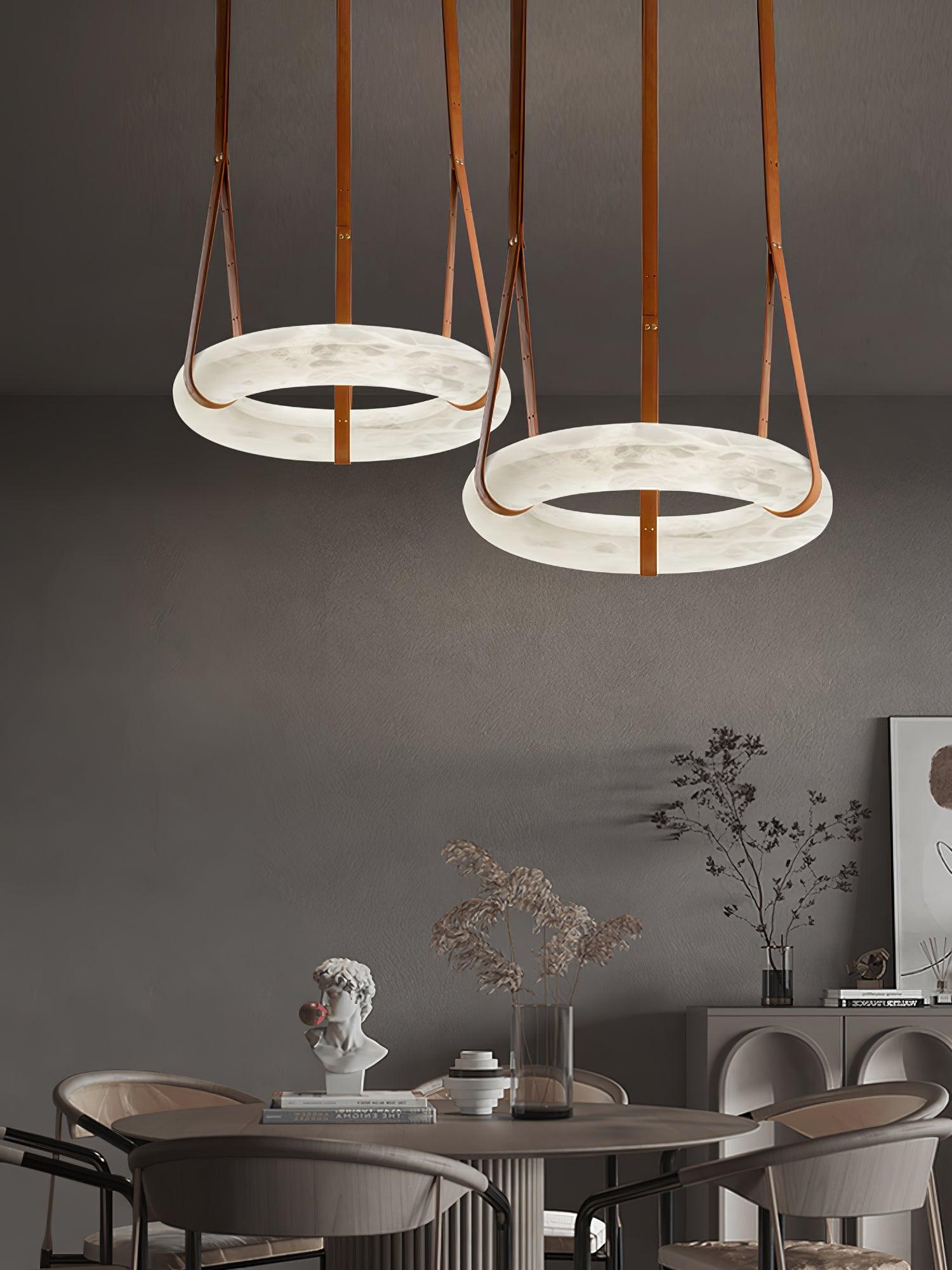 Two ring pendants above a dining area