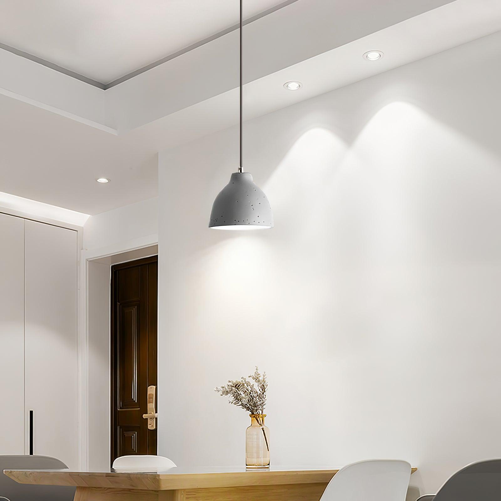 Grey bowl pendant above a table near a doorway