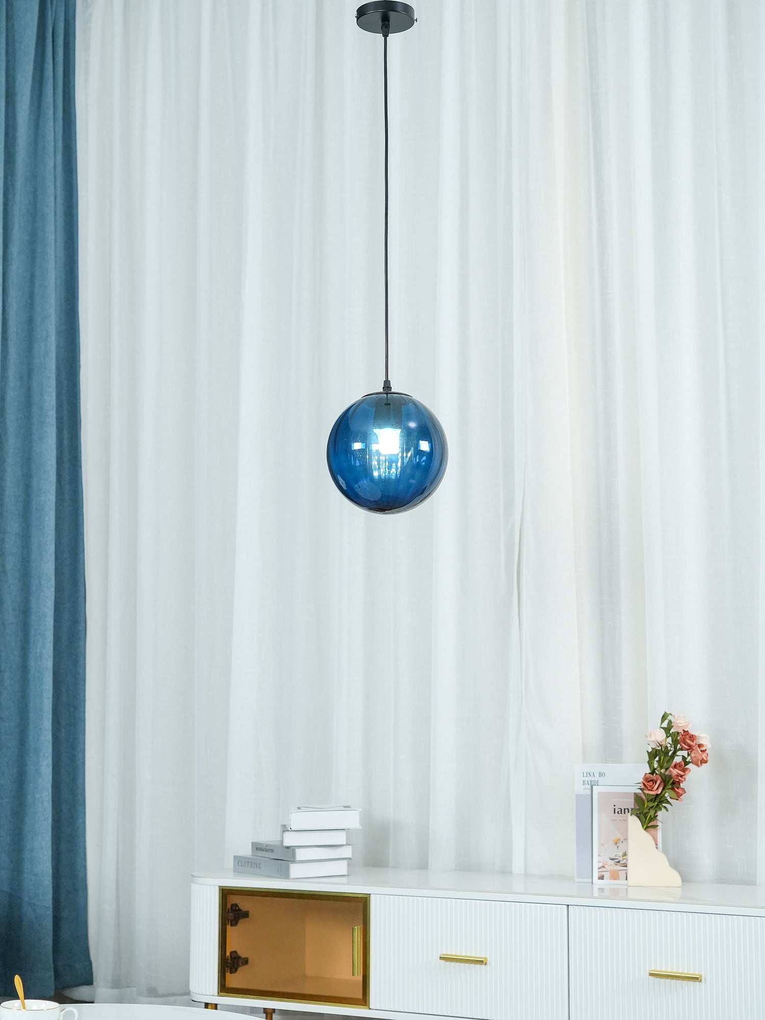 Paola pendant light with a coloured glass globe and small metal cap