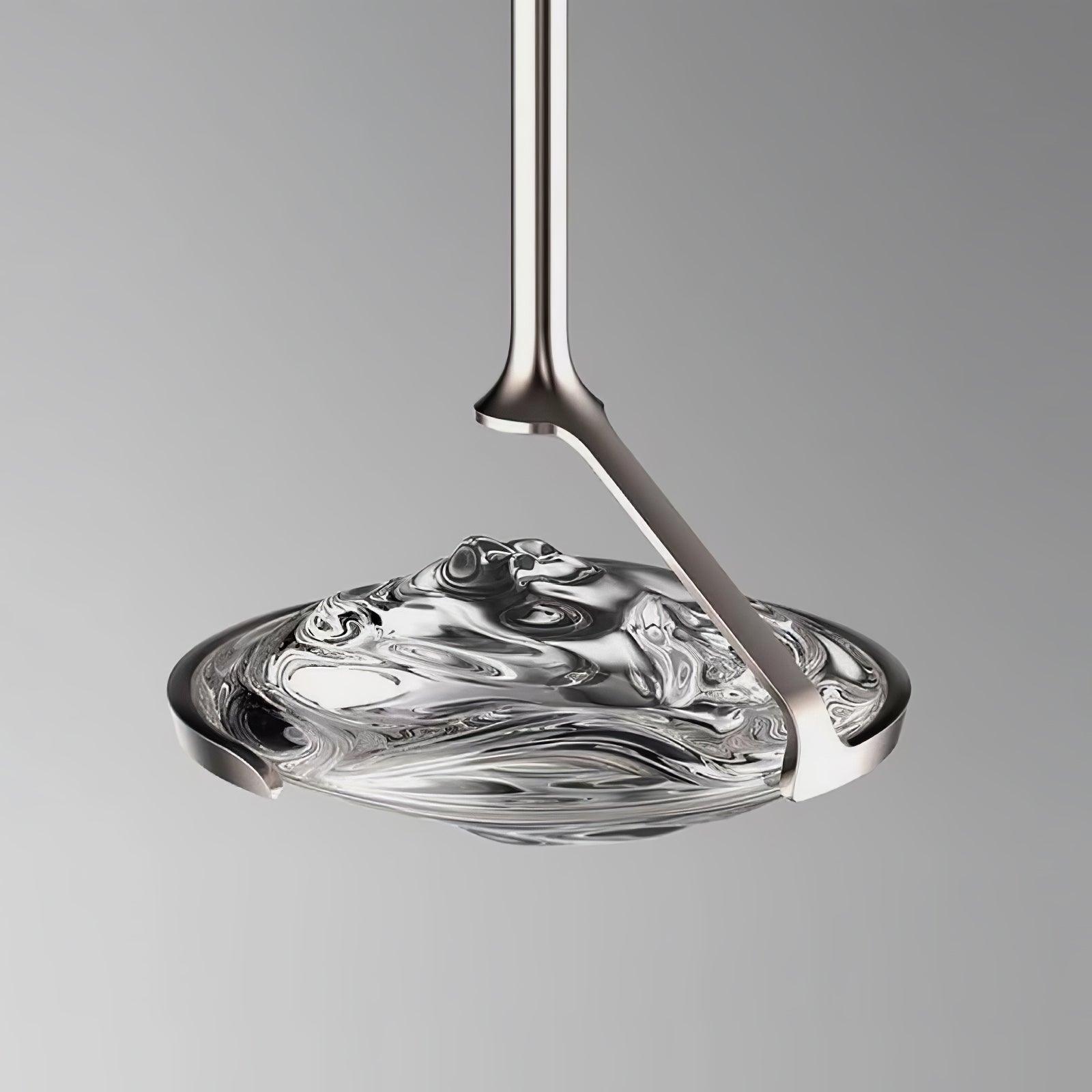 Close upper view of chrome-looking angled support and open cradle around smoky rippled glass