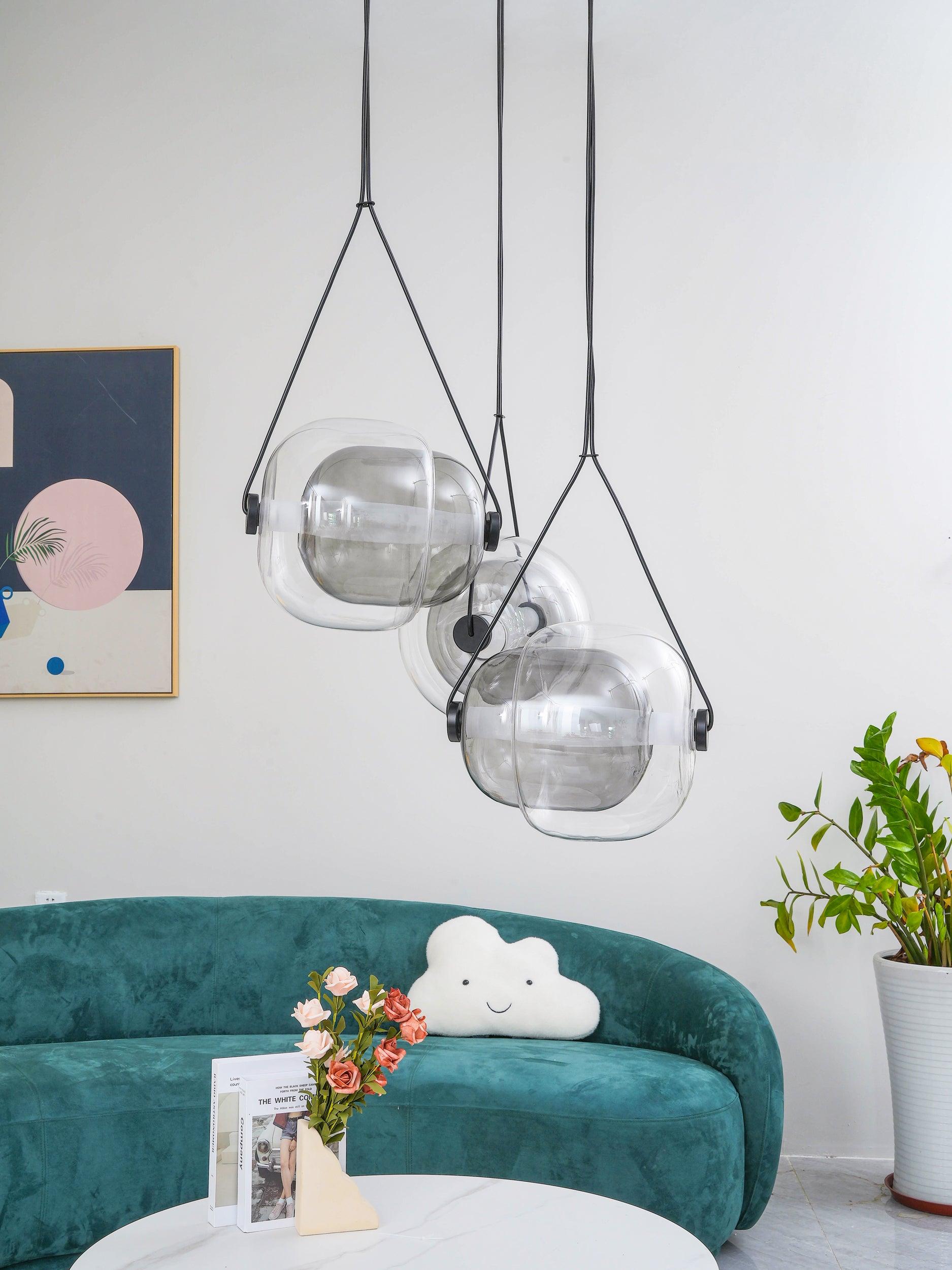 Two clear glass pendants over a sitting area