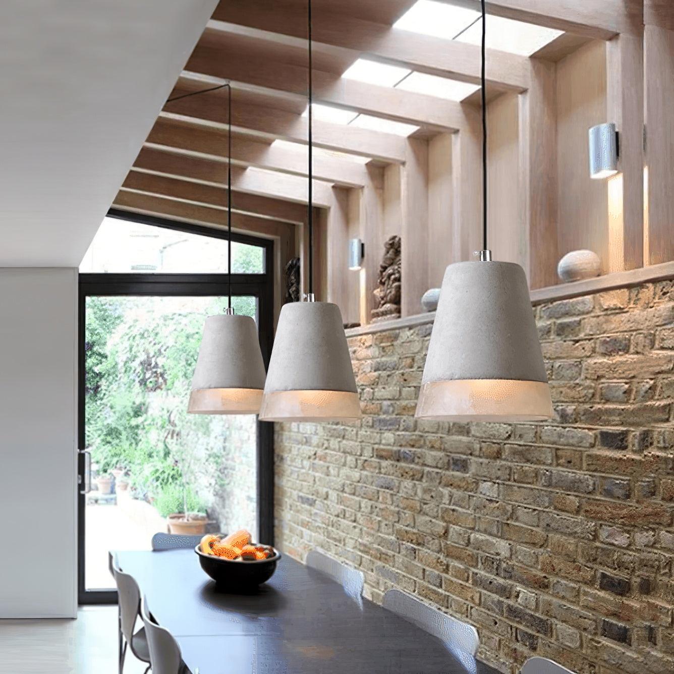 Tapered pendant arrangement beside a stone wall