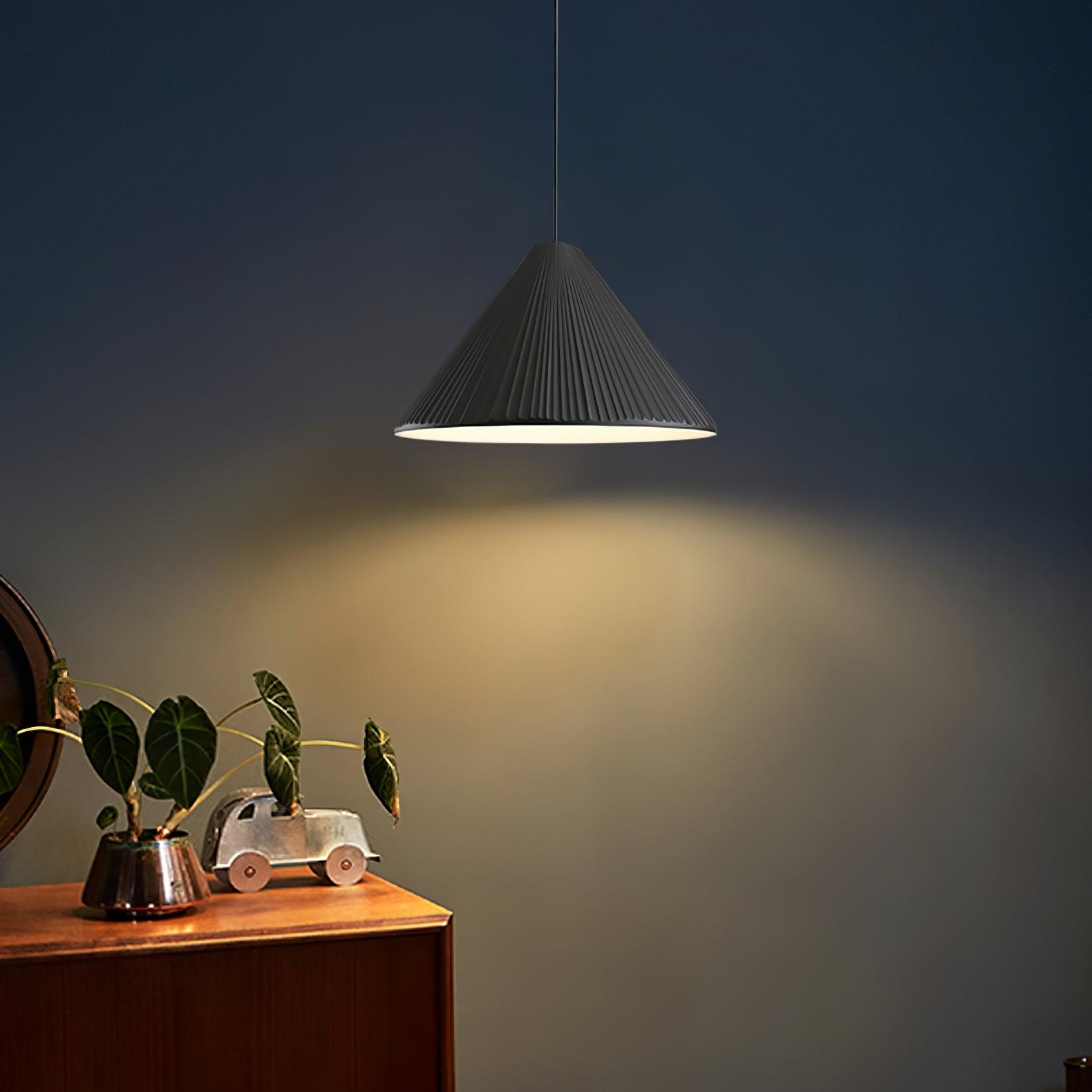Black pleated pendant over a cabinet