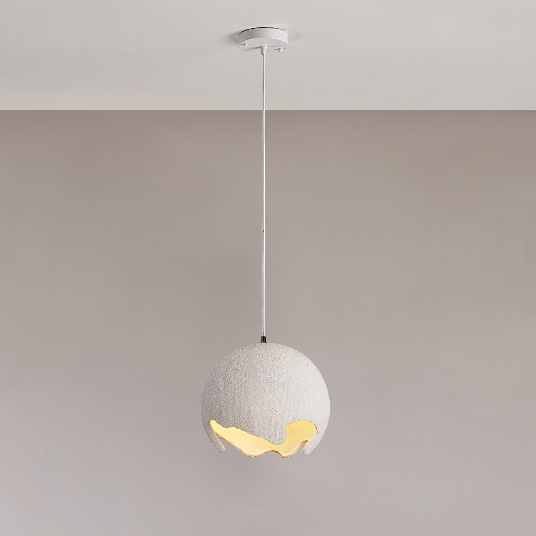 White textured globe pendant suspended beneath a pale round canopy