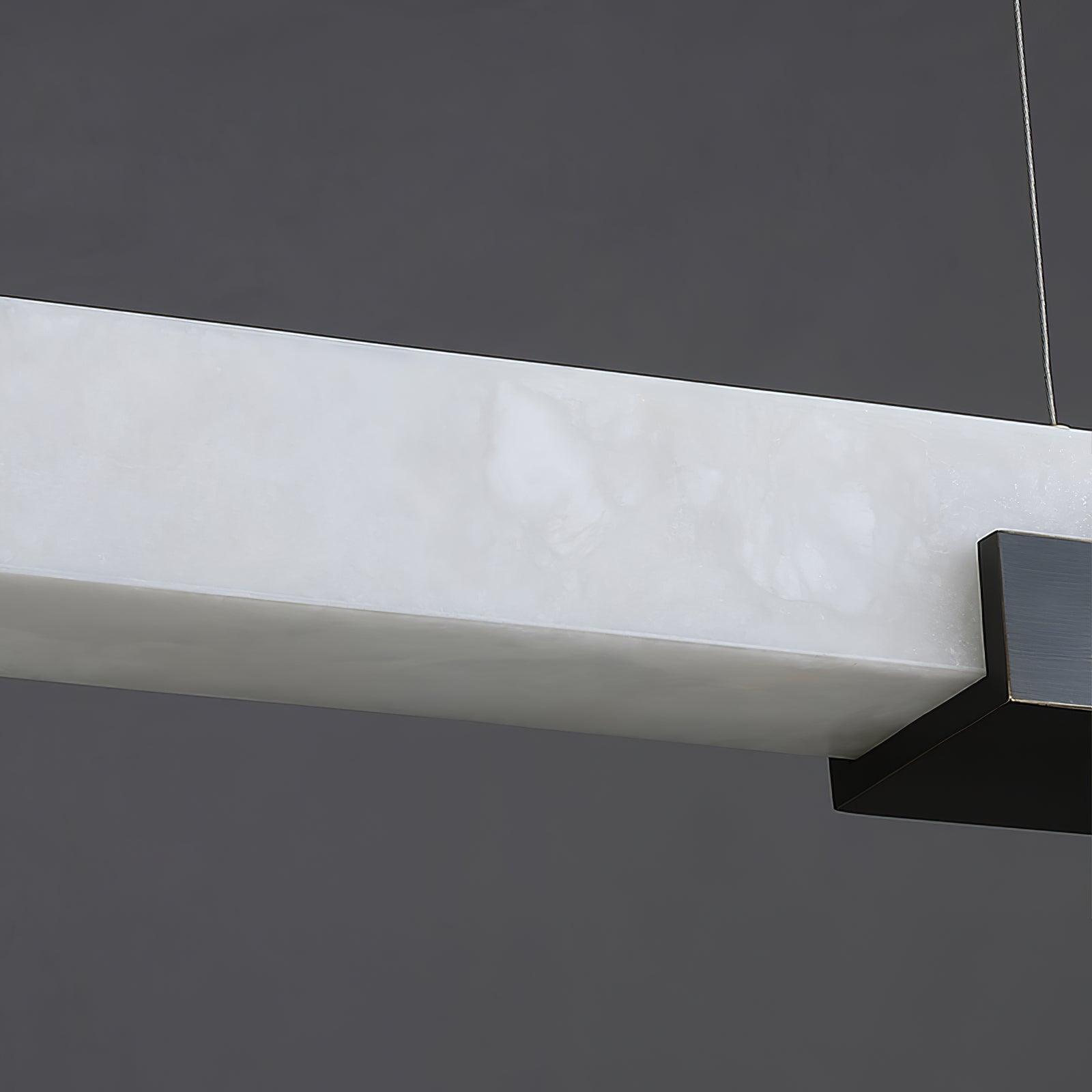 Close-up of white veined pendant bar and dark support underneath its right end