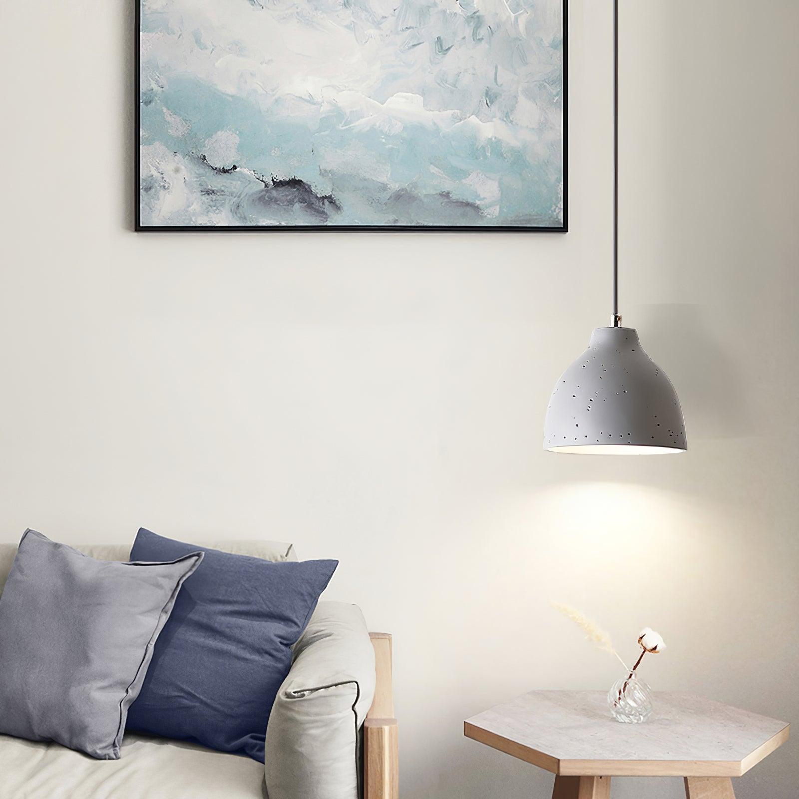 White bowl pendant above a side table and flowers