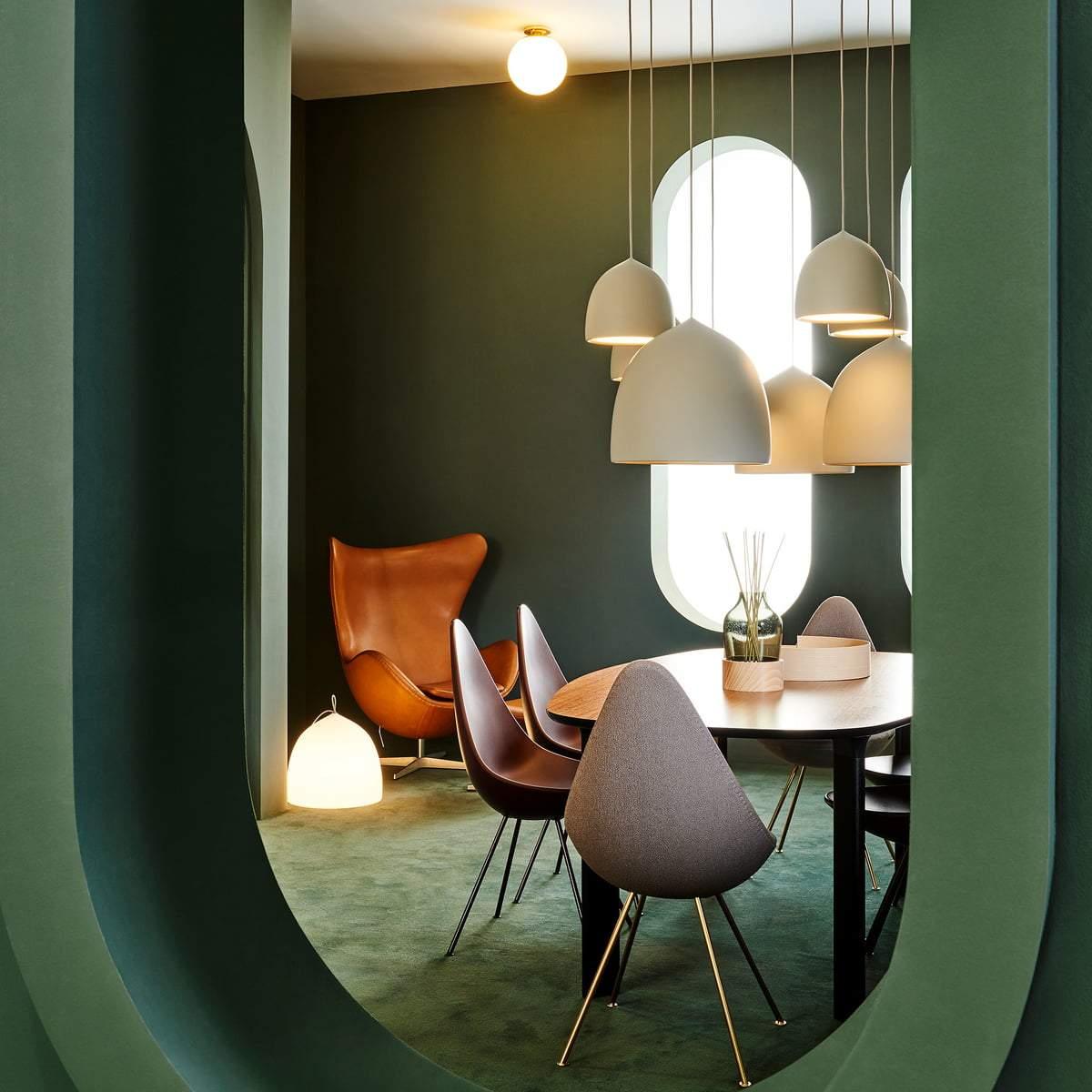 Cluster of bell pendants around a dining setting