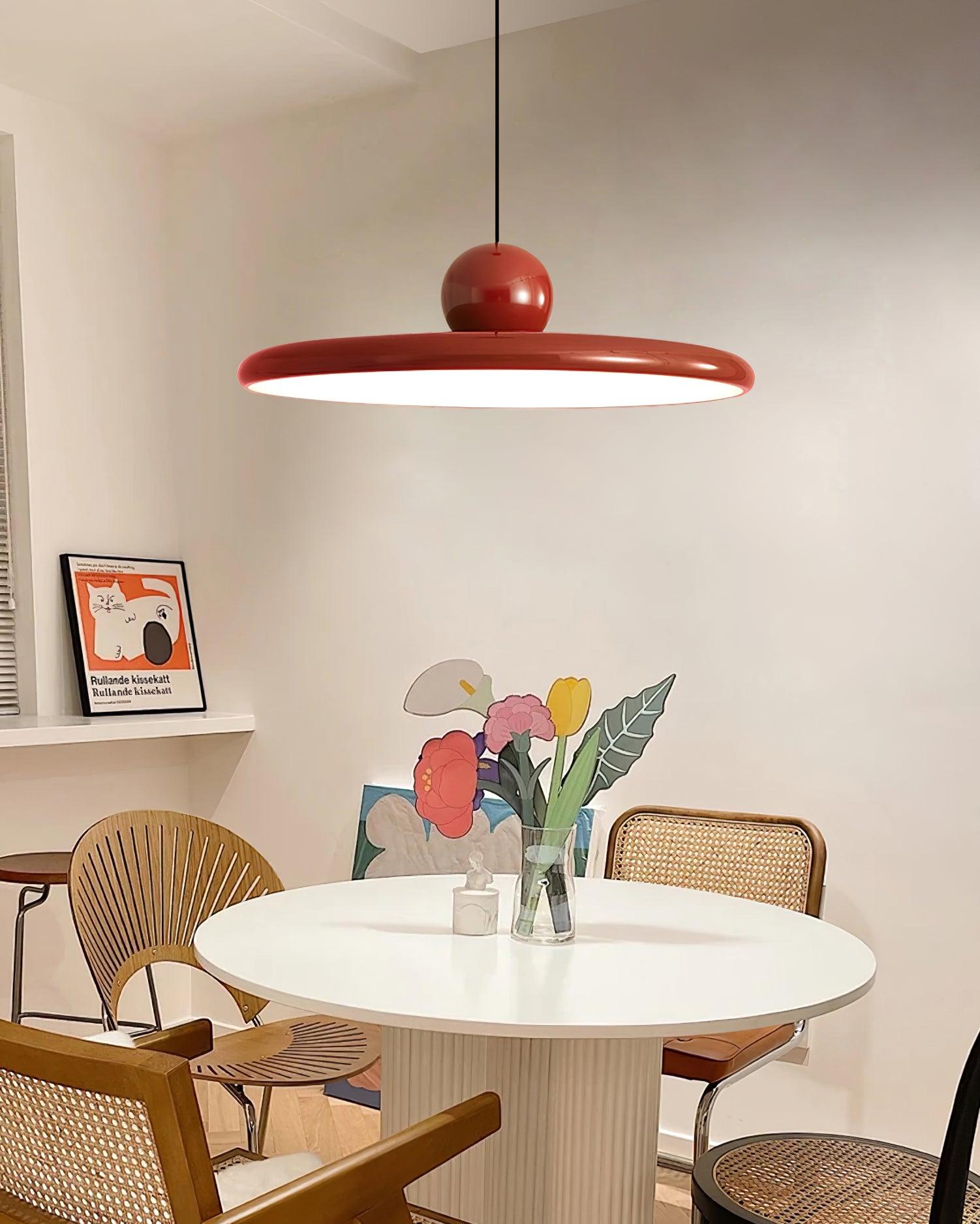 Red Lola pendant above a white table with flowers