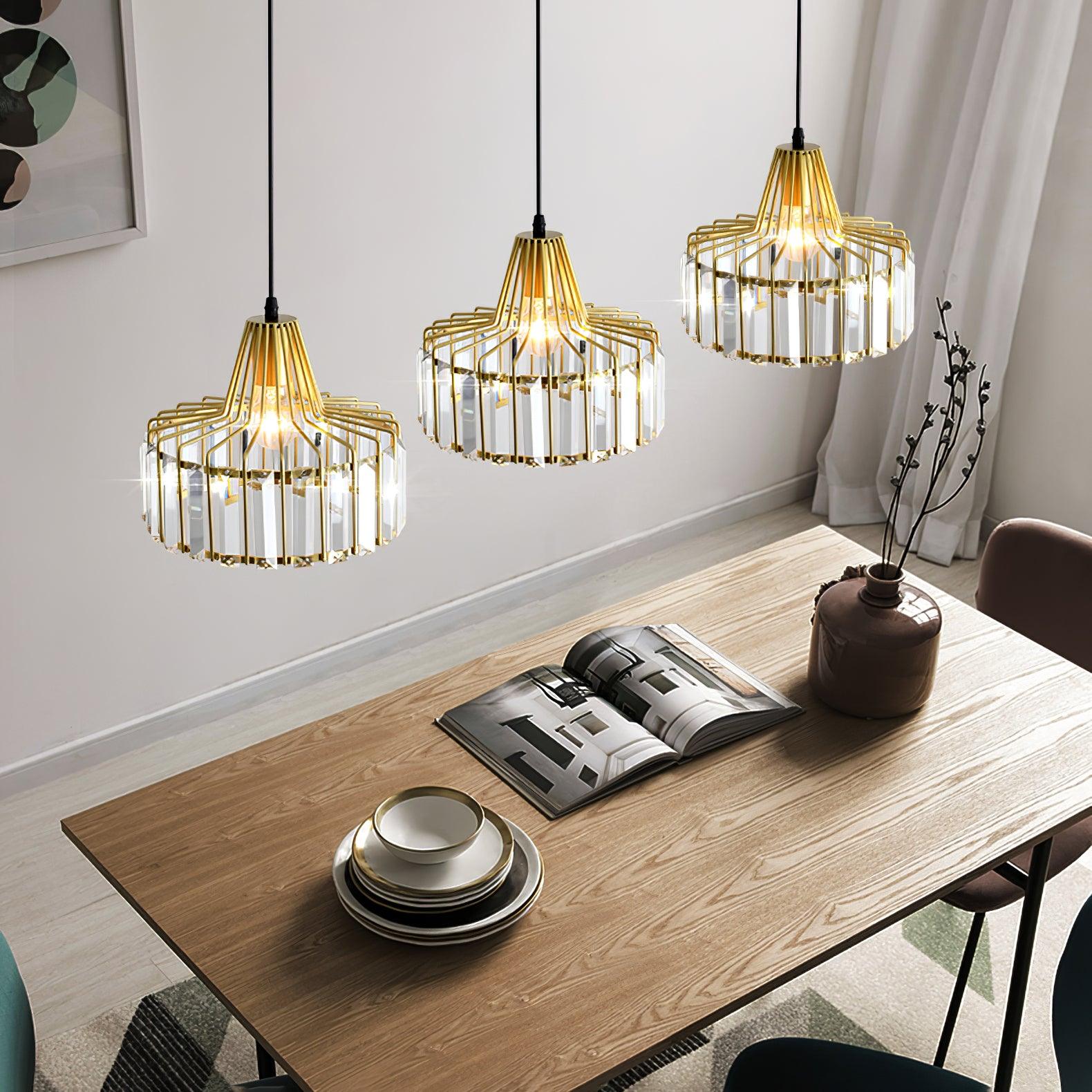 Three gold-coloured pendants above a wooden table