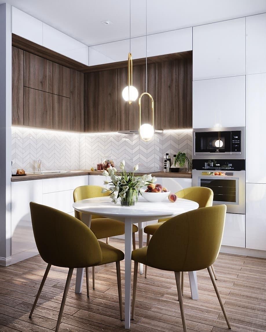 Two oval pendants above a kitchen dining arrangement