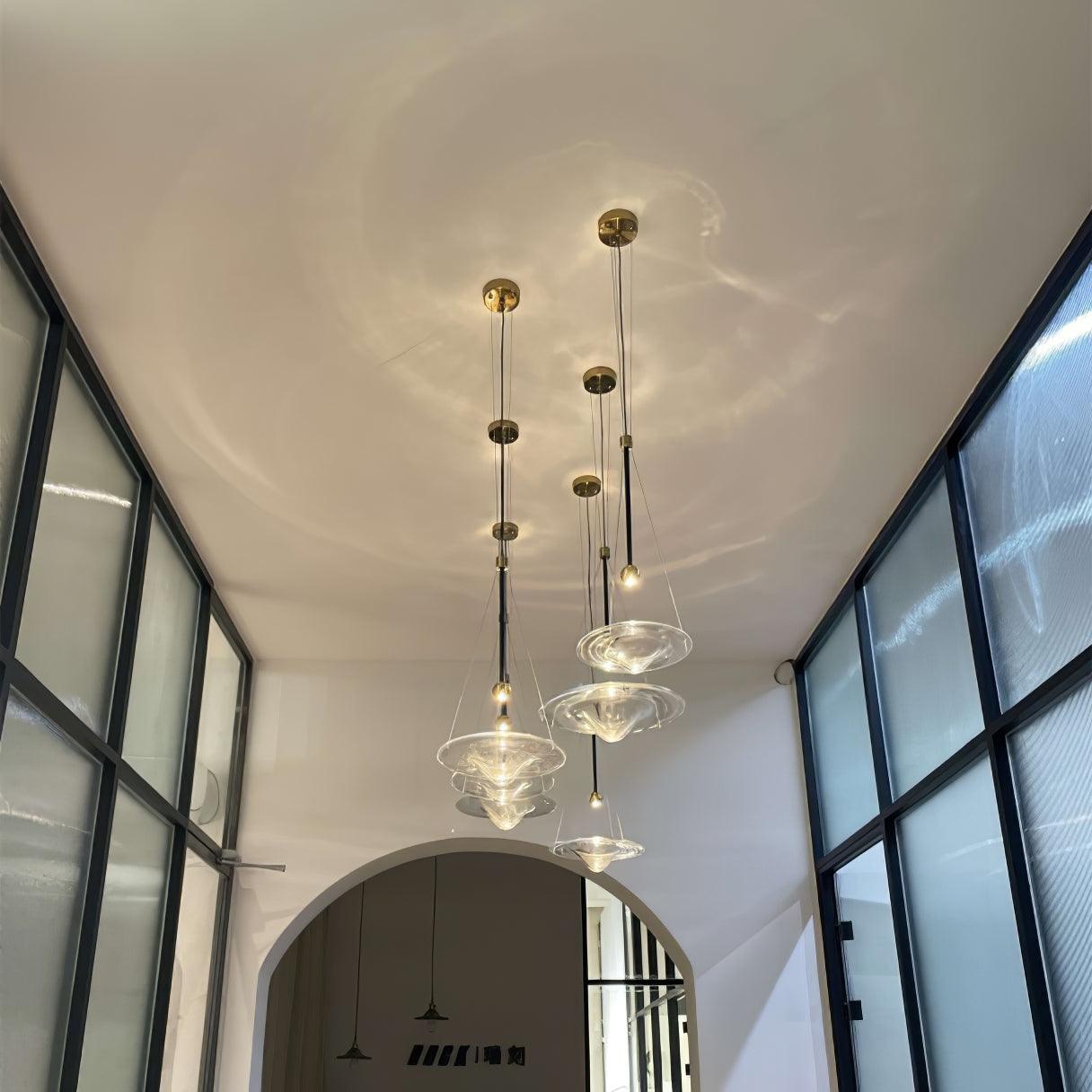 Several glass disc pendants in a tall stairwell