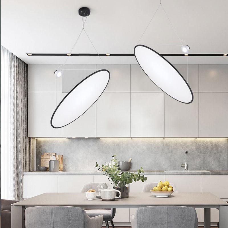 Angled circular pendants above a kitchen island