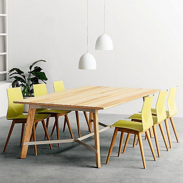 Two white bell pendants over a long wooden table