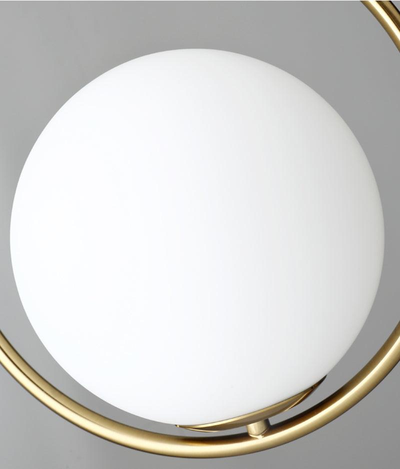 Close-up of white glass globe seated inside the lower frame curve