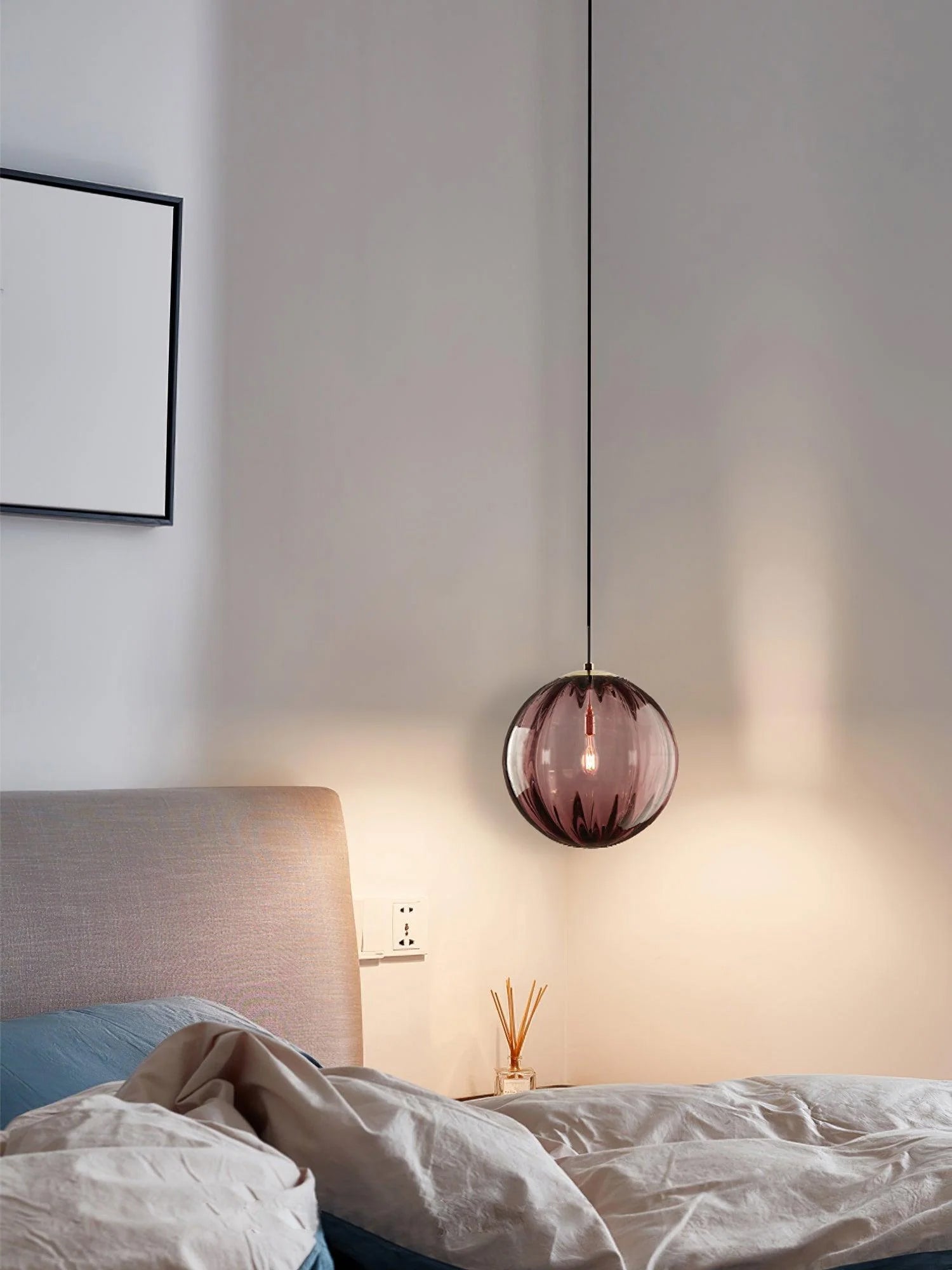 Paola pendant light with a coloured glass globe and small metal cap
