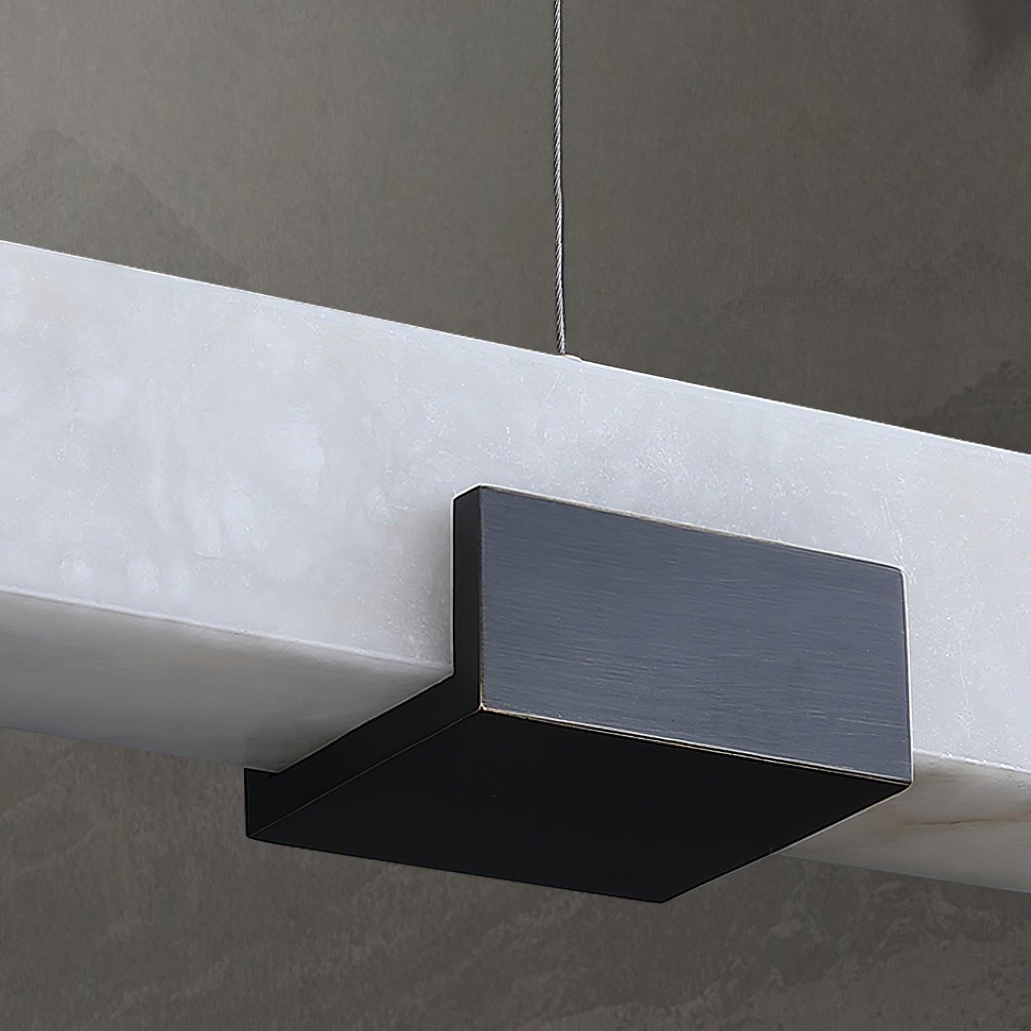 Close-up of dark brushed support beneath white veined pendant bar with cable above