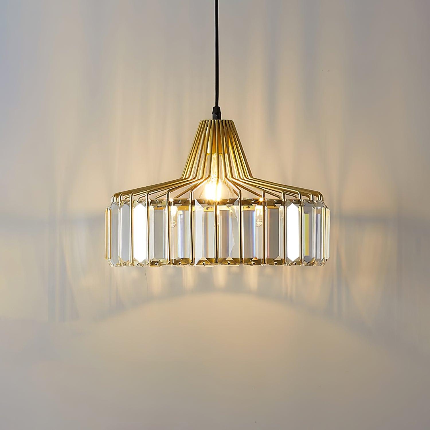 Lit gold-coloured drum shade against a pale wall