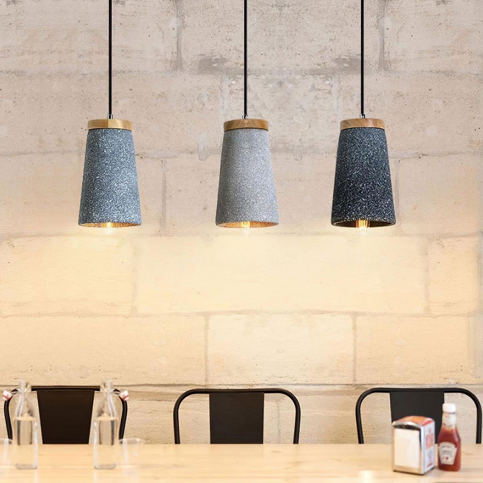 Three cement pendants arranged in an interior row
