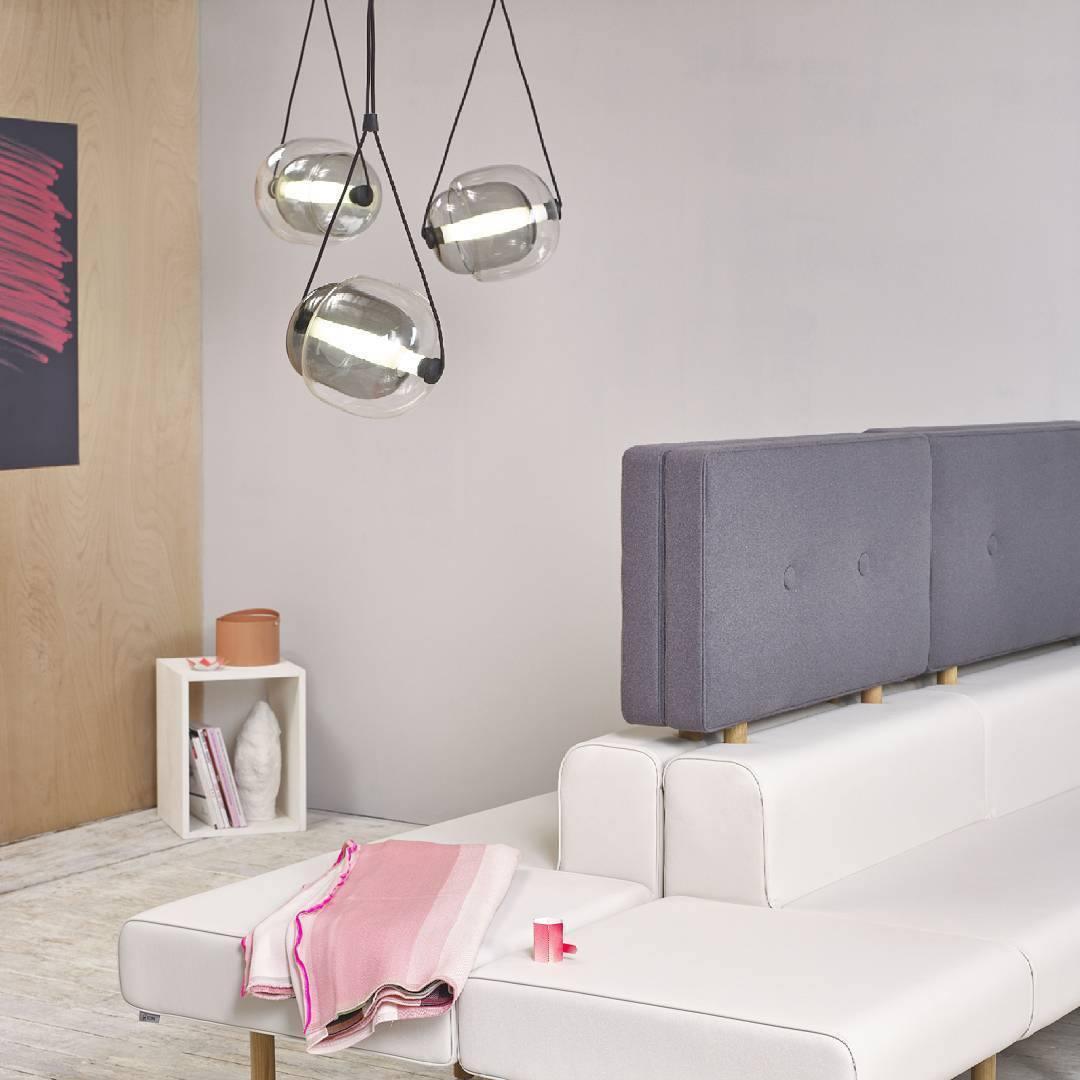 Small clear pendants beside a bed