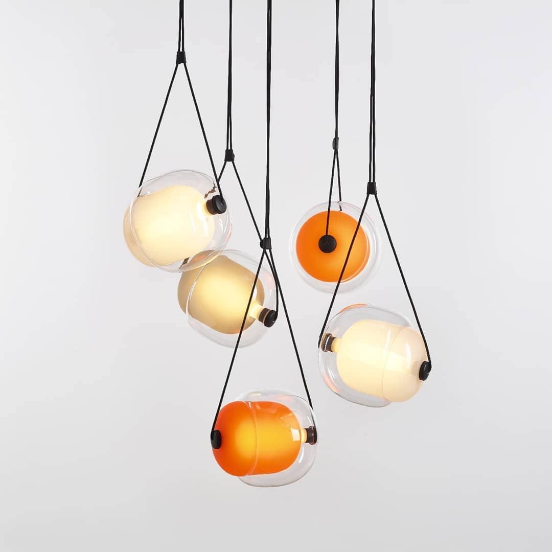 Grouped opaline and orange-toned pendants