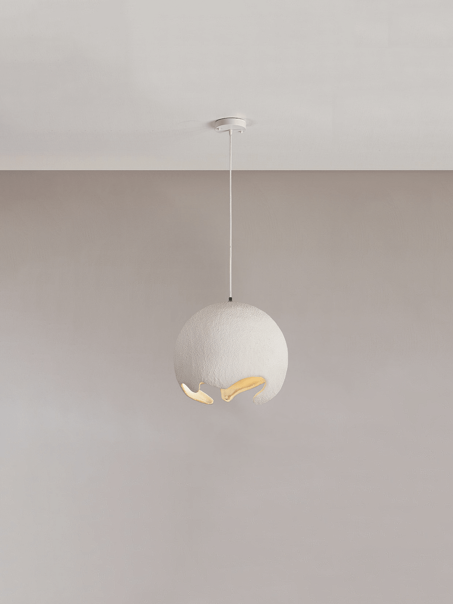 Small white globe pendant against a pale wall