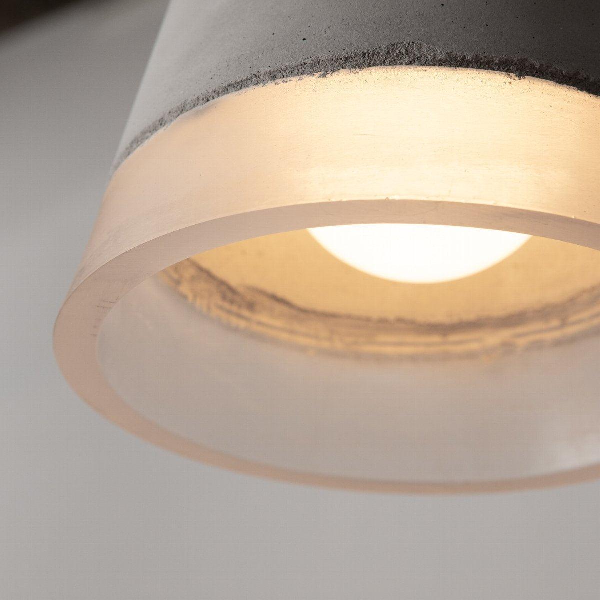 Close view of glowing resin band and bulb beneath the shade
