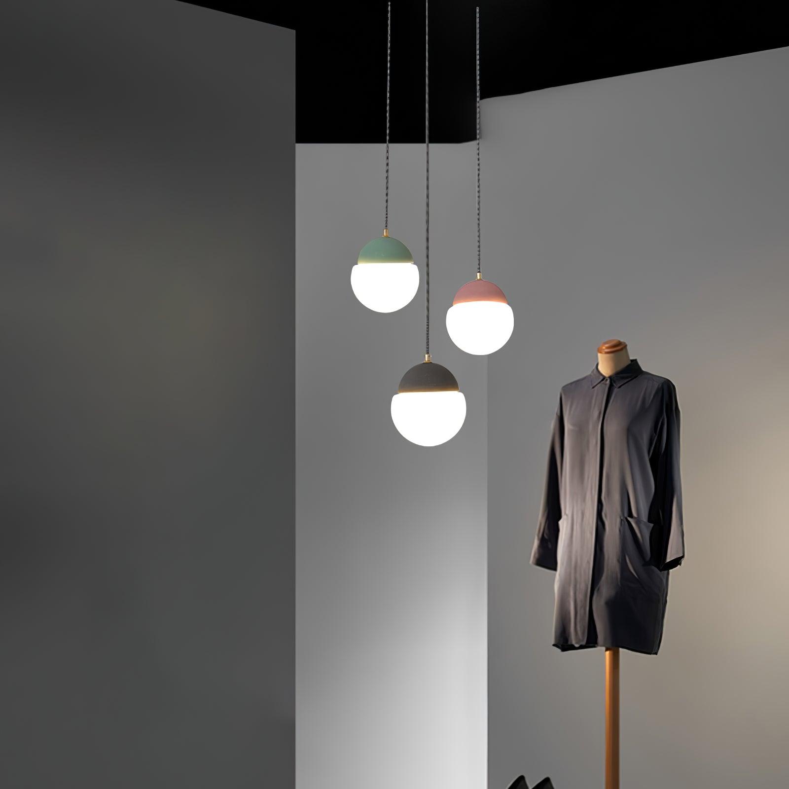 Coloured globe pendants beside a coat stand