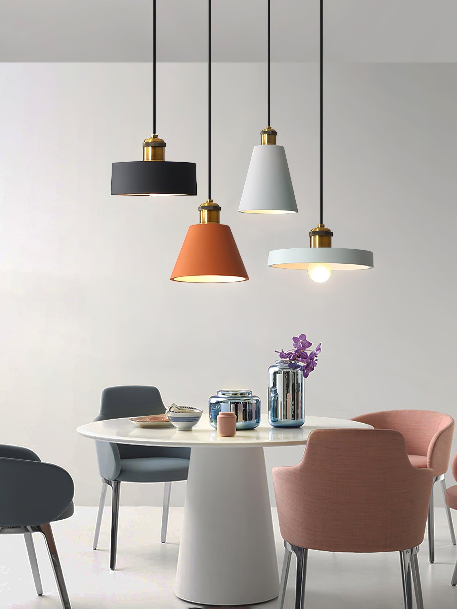 Four mixed pendants above a dining table