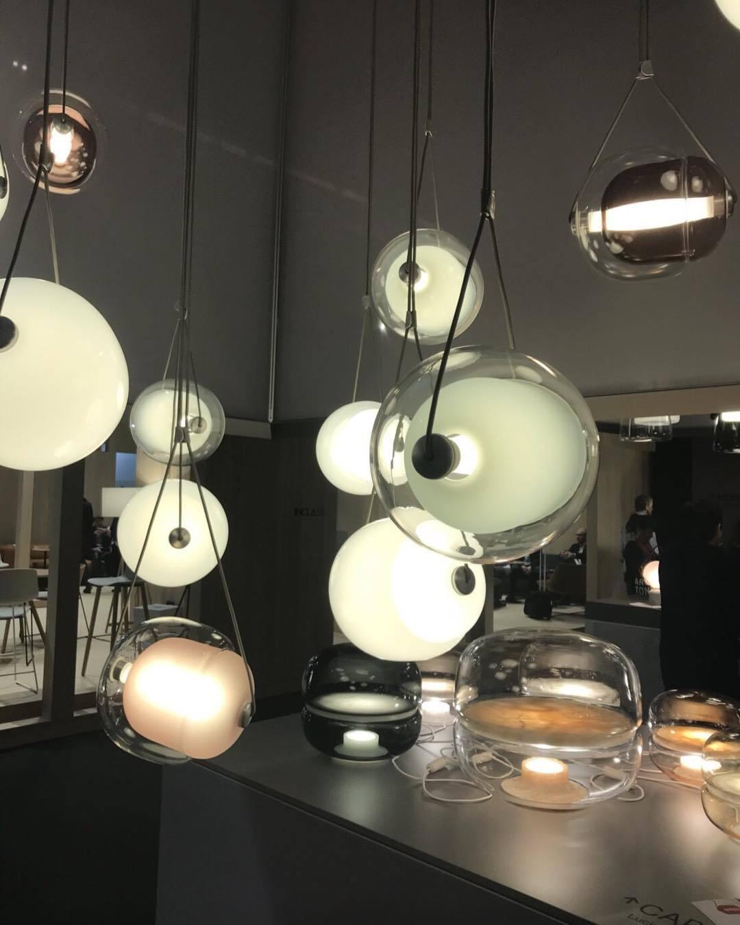 Group of glass pendant lights above a display counter