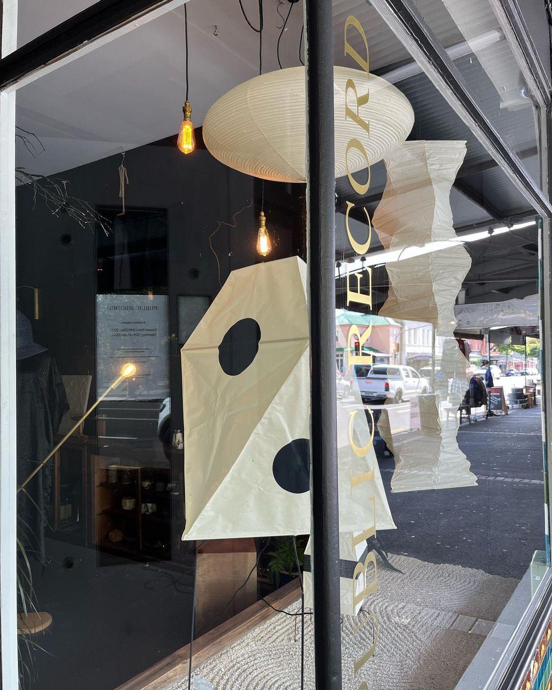 Lighting showroom window with several paper shapes