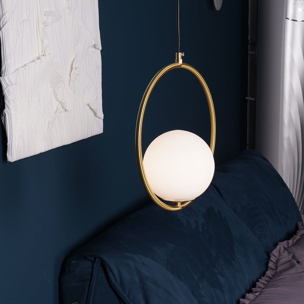 White globe inside a circular frame above a blue sofa