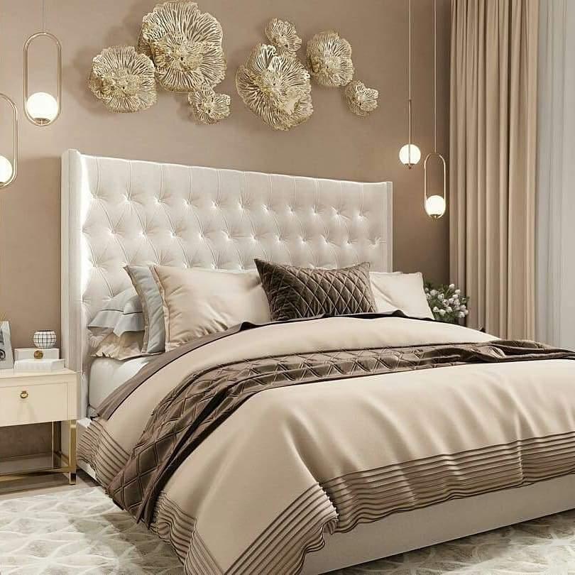 Paired globe pendants beside an upholstered bed