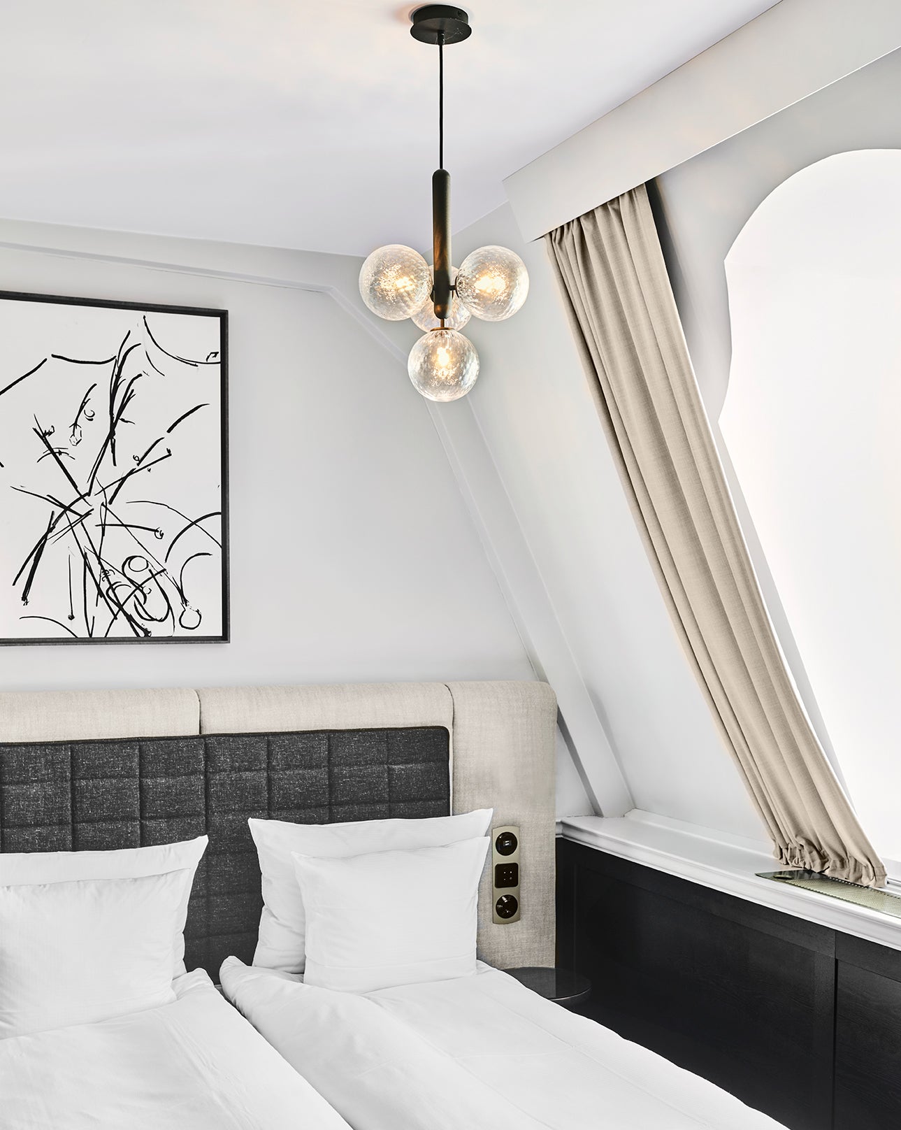 Clear globe cluster above a bedroom