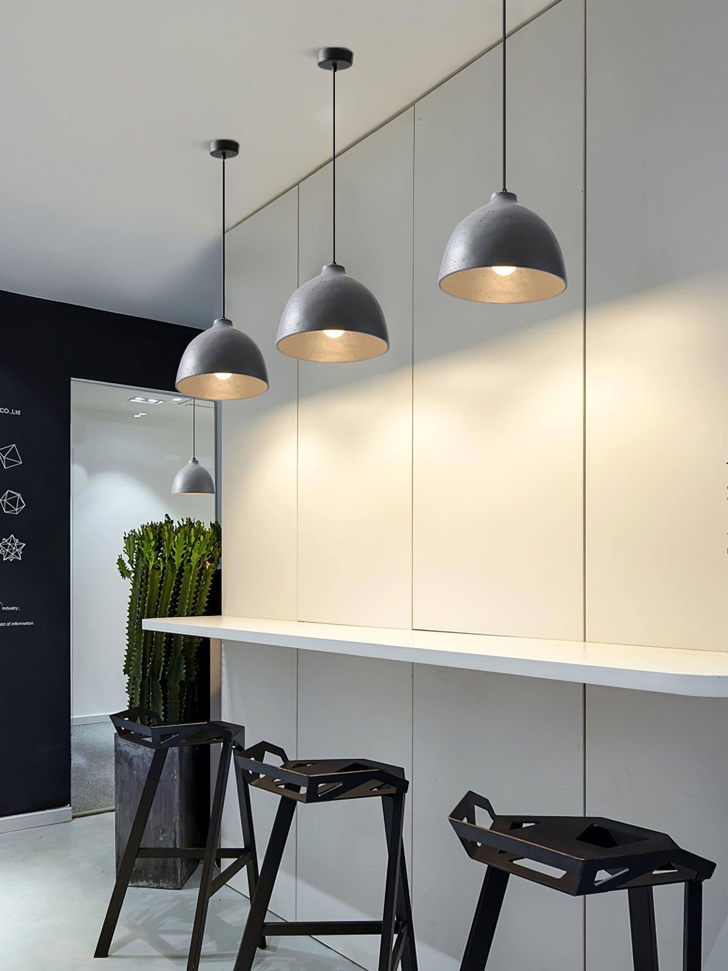 Grey pendants illuminating an indoor counter