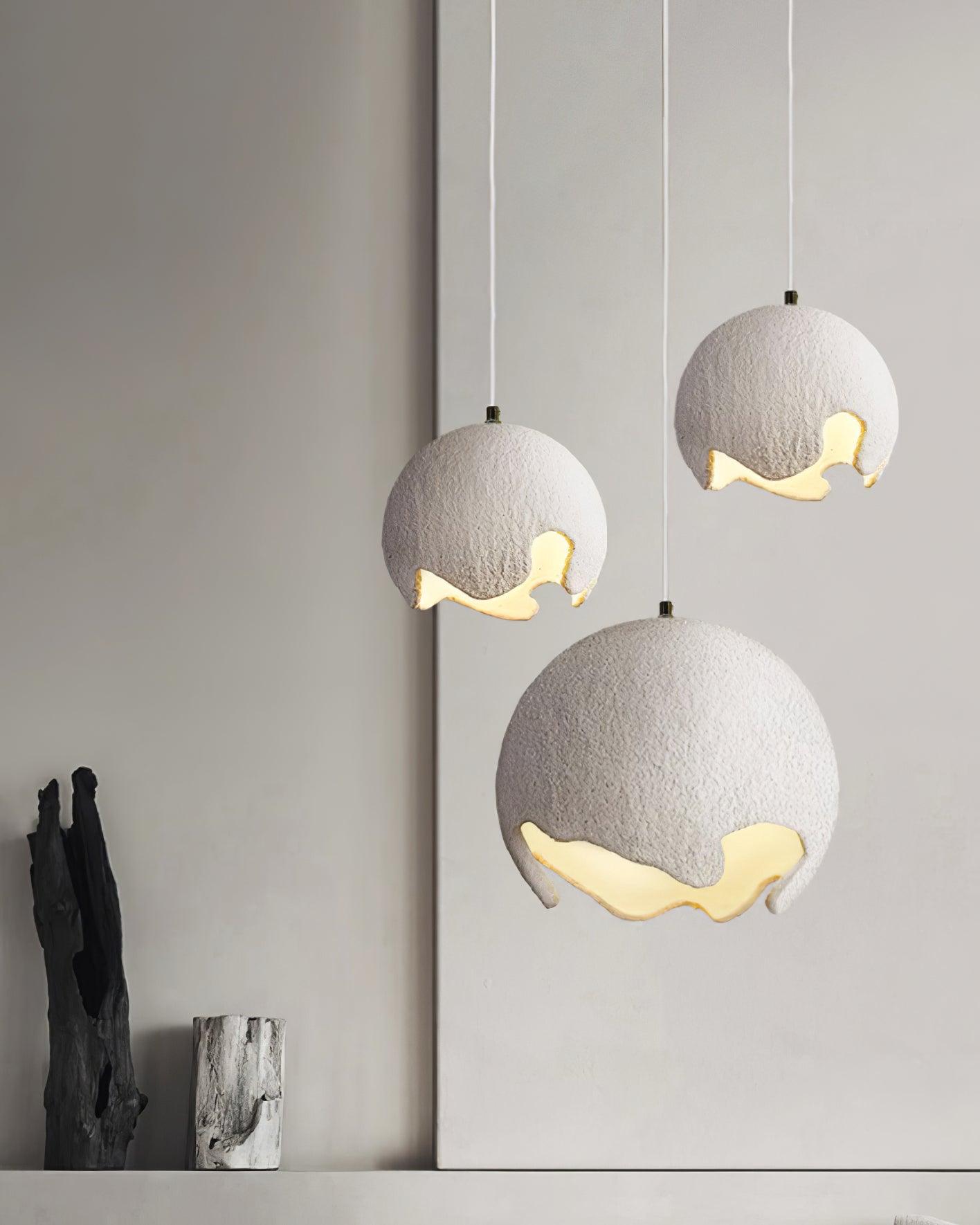 White textured pendants in a varied-height arrangement