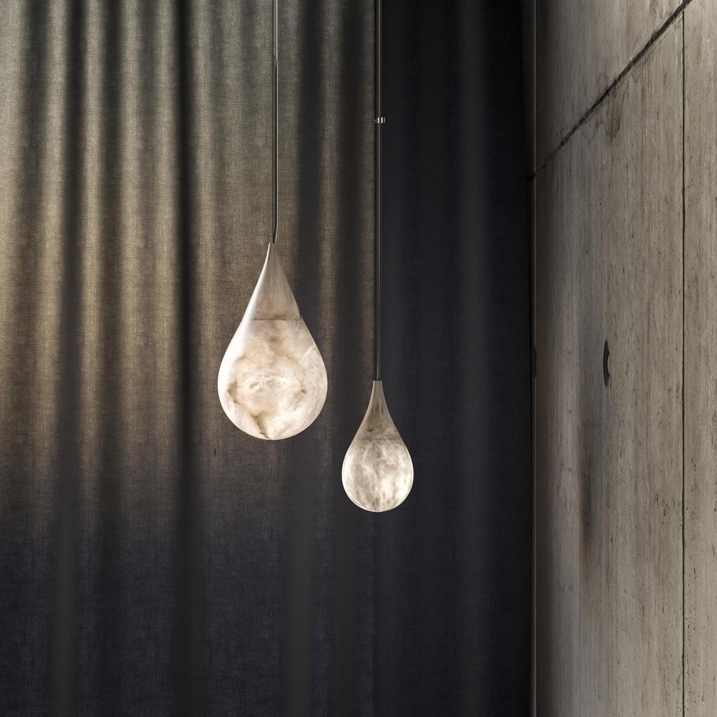 Two marble droplet pendants near curtains