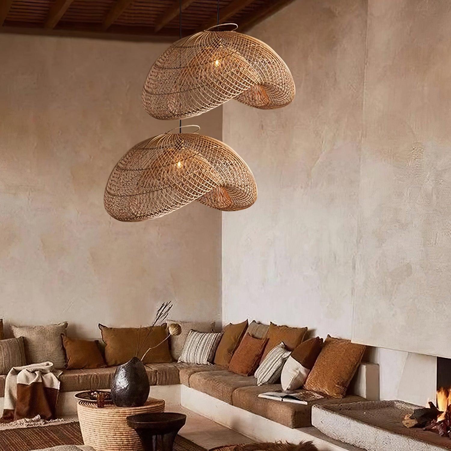 Two woven wave pendants above an earth-toned corner sofa with cushions, round table and fireplace