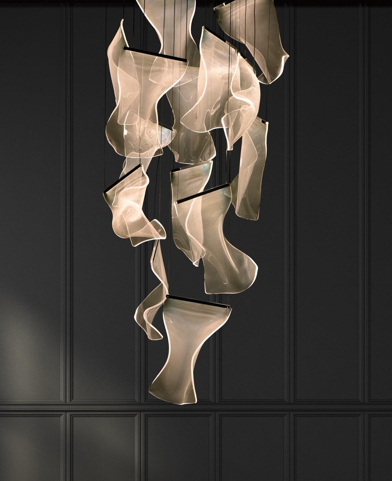 Long arrangement of lit acrylic waves against a dark wall