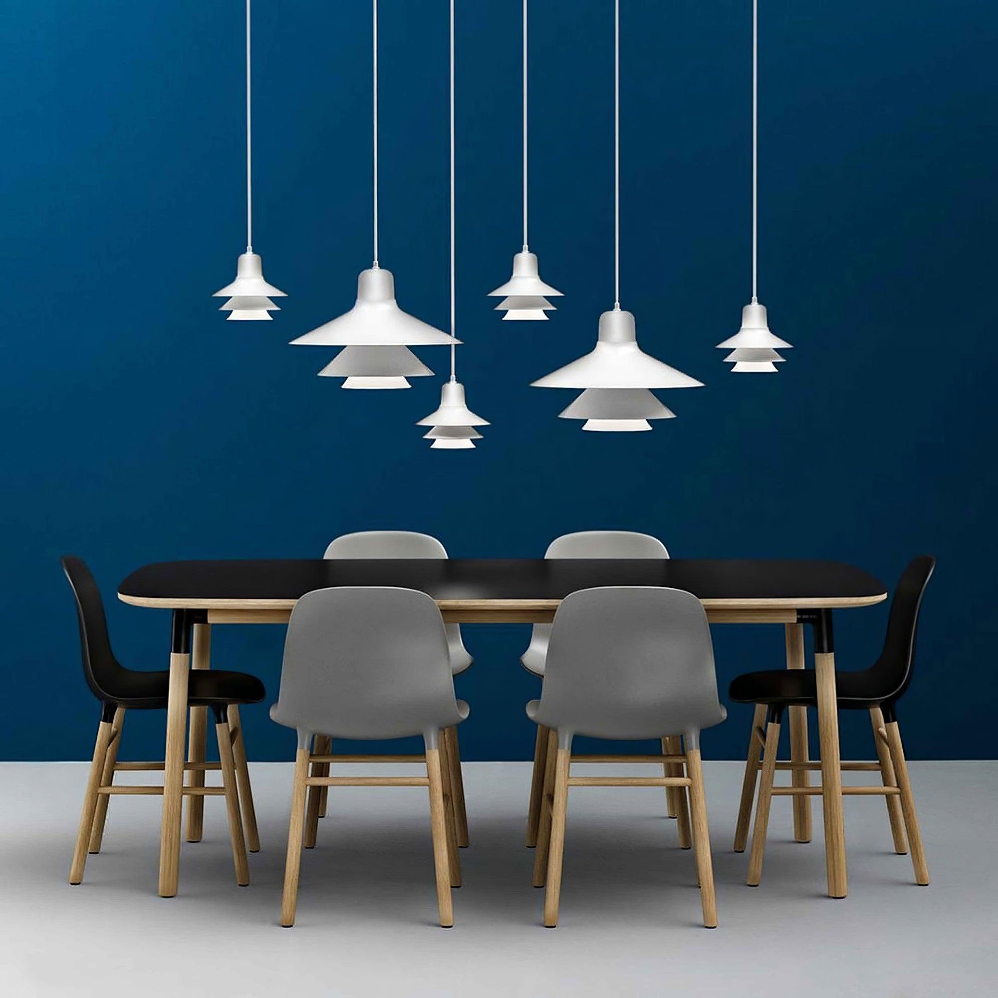 Multiple White pendants above a dining table