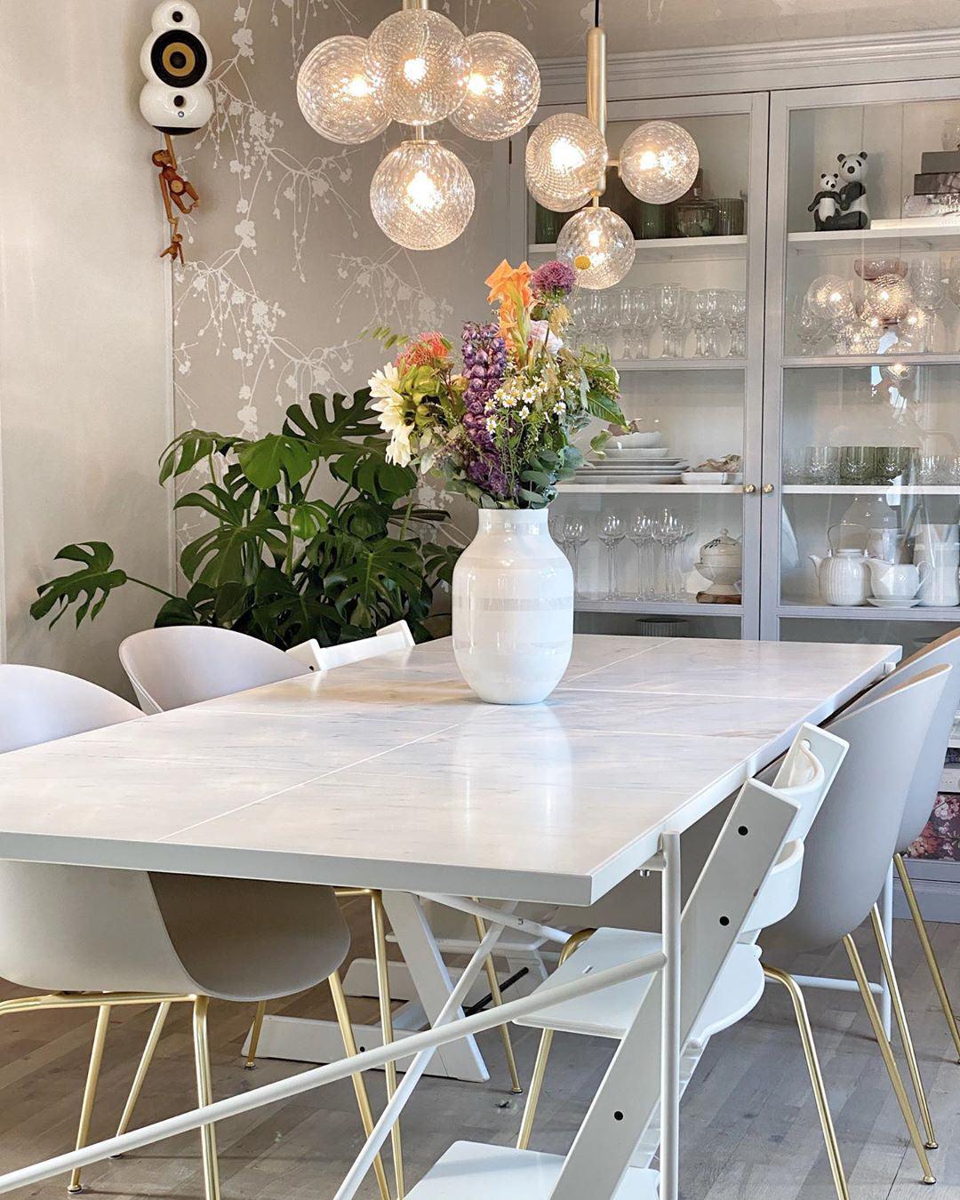 Clear patterned globes above a vase of flowers